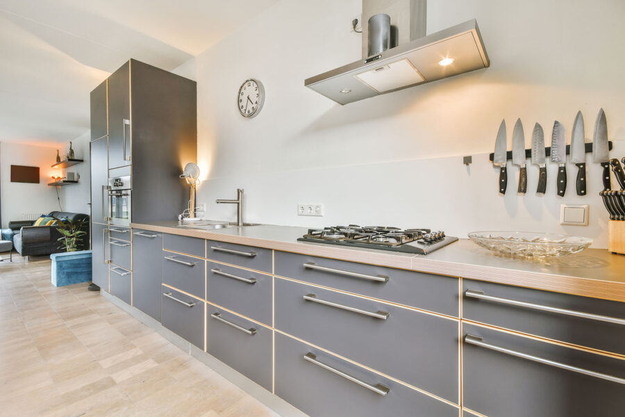 Modern kitchen with gray cabinets, stainless steel appliances, and a gas stove