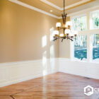 Empty room with new hardwood flooring and large windows