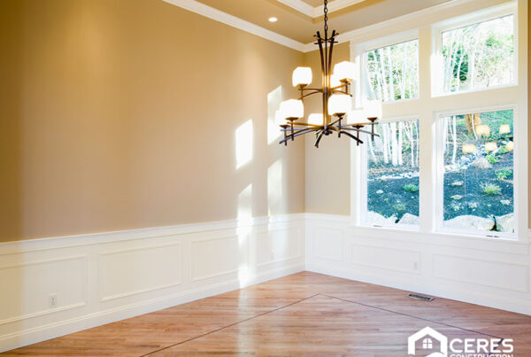 Empty room with new hardwood flooring and large windows